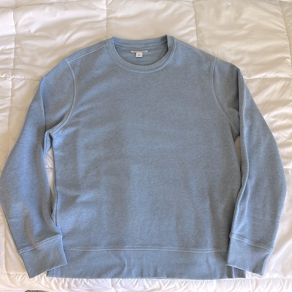 A large, blue sweater from the brand Amazon Essentials.